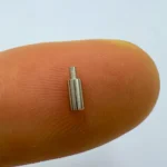 High - precision stainless steel micro rod, CNC machined for use in miniature electronic devices, showcasing fine craftsmanship.