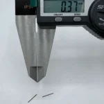 High - precision CNC machined micro pins measured by digital calipers, showing 0.37mm diameter, ideal for electronics assembly.