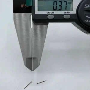 High - precision CNC machined micro pins measured by digital calipers, showing 0.37mm diameter, ideal for electronics assembly.