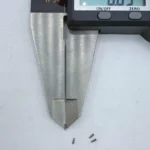 Micro stainless steel pins, CNC machined, being measured by a digital caliper, suitable for high - precision electronics assembly.