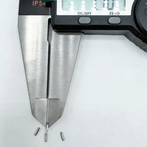 Stainless steel micro pins, precision CNC machined, being measured by a digital caliper, ideal for high - tech electronics.
