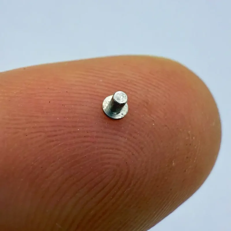 Micro fastener made of stainless steel, precisely CNC machined, perfect for miniature mechanical assemblies.