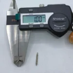 Digital caliper measuring dimensions of stainless steel worm gear shaft