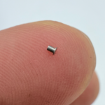 Hand holding micro stainless steel turned precision pin