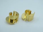 Two gold CNC machined precision components displayed together