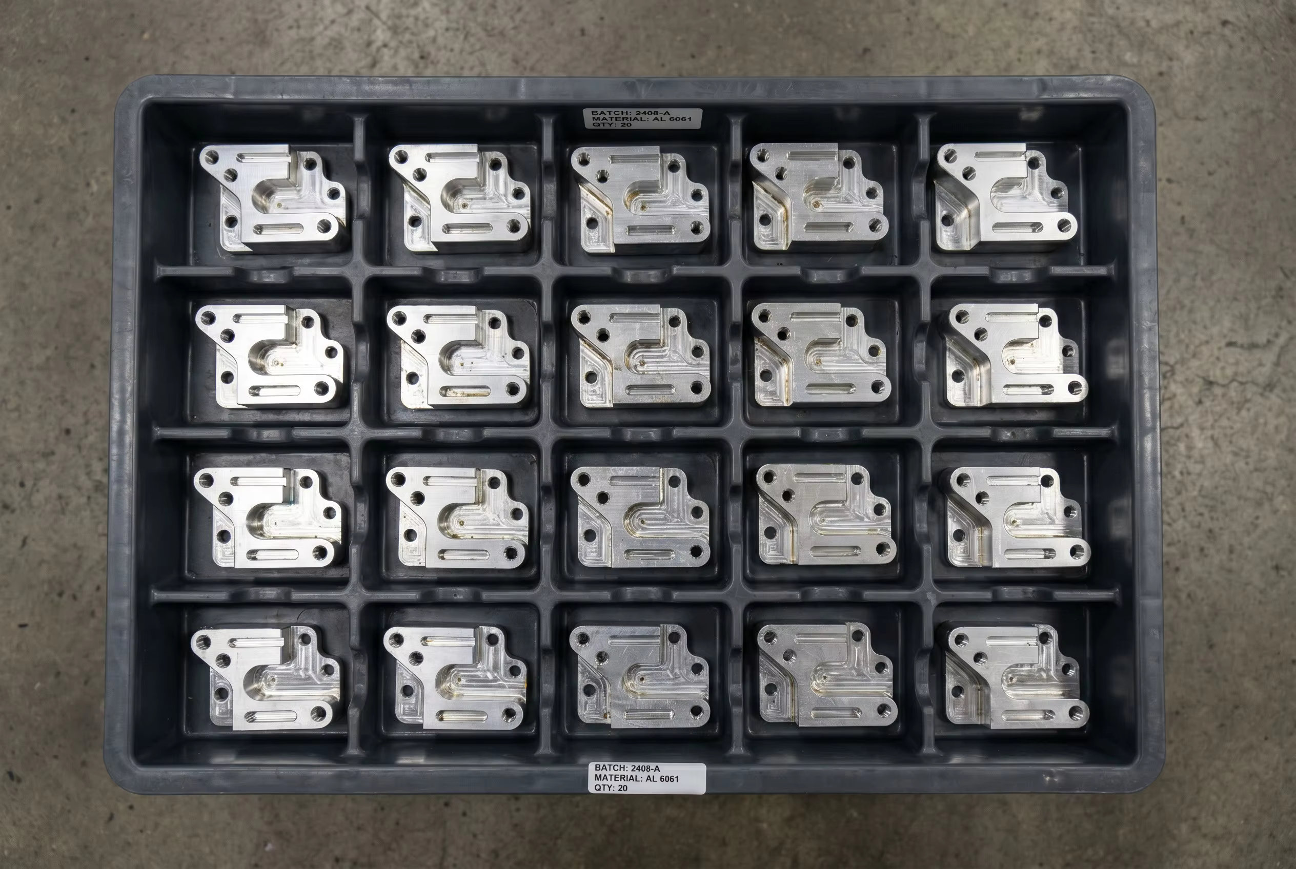 An organized tray of identical high-precision CNC machined aluminum components ready for final quality inspection and batch delivery by JXD Machining.